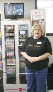 Vicki Brickell, community counseling secretary at ESU and a co-owner of Blue Fox Inc., welcomes students and faculty at the grand opening of the DVD Kiosk in the Memorial Union. The Kiosk will provide an on-campus source of movie rentals for students that live on campus and 10 percent of the profits will be given back the Memorial Union each month. KAITHI WALKER/THE BULLETIN