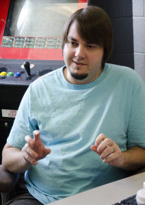 Jeremy Aber, instructor of physical sciences, discusses his job and his leisure time in his office. Aber moved his Neo-Geo arcade game into his office for storage as well as a break for both him and his students.Jenny Pendarvis/The Bulletin