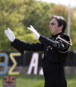 Ben Reilly, senior music education and music performance major, conducts the halftime performance during the football game Saturday at Welch Stadium. Reilly is the head drum major in the marching band.Yohan Kim/The Bulletin