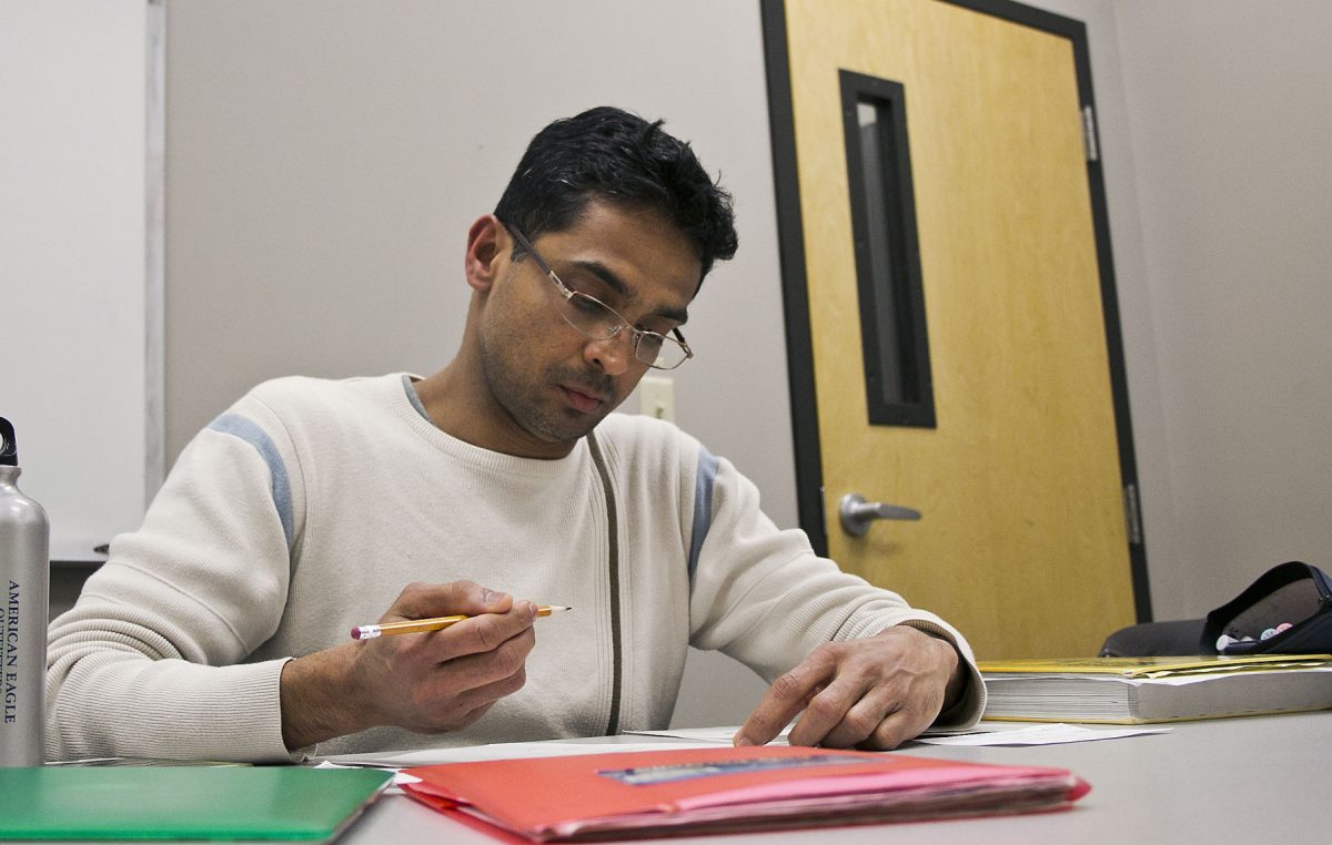 Chamil Fernando, senior biochemistry and molecular biology, works on his assignment for trigonometry on Monday in the William Allen White Library. Though Fernando enrolled into the university as a nontraditional student, he has found his passion that will lead to helping people and would like to do research about clinical nutrition in the future.