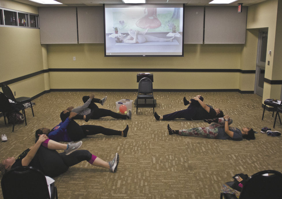 Students participate in physical exercises as part of the Homegurl Remedies event hosted by the Black Student Union last Wednesday. The event, which focused on self-care tips for women, was held as part of BSUs celebration of Women&#8217;s History Month.