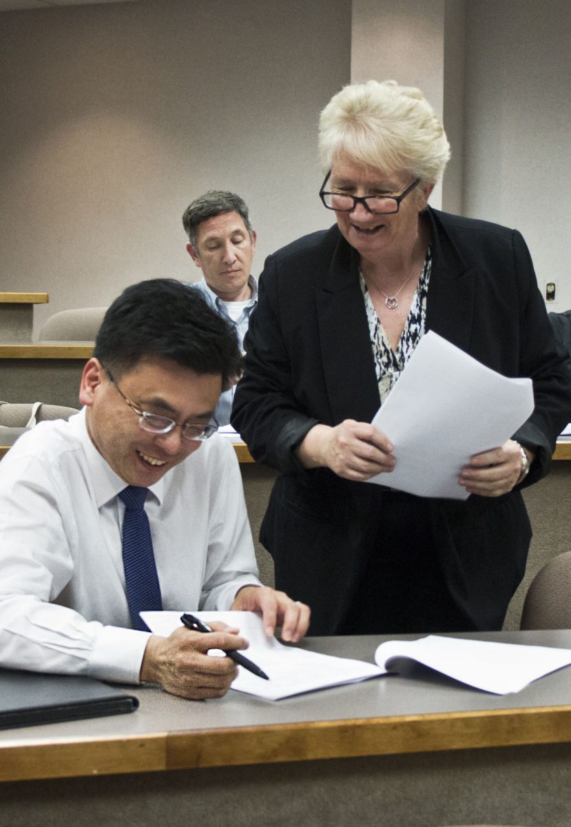 Jolanna Kord, instructor of designing and using rubrics to measure student learning seminar, and Wooseob Jeong, dean of school of library and information management, discuss how to design rubrics based on assignments last Friday in Vissor hall 330. The professional development workshop was to assist faculty and staff in implementing student outcomes.