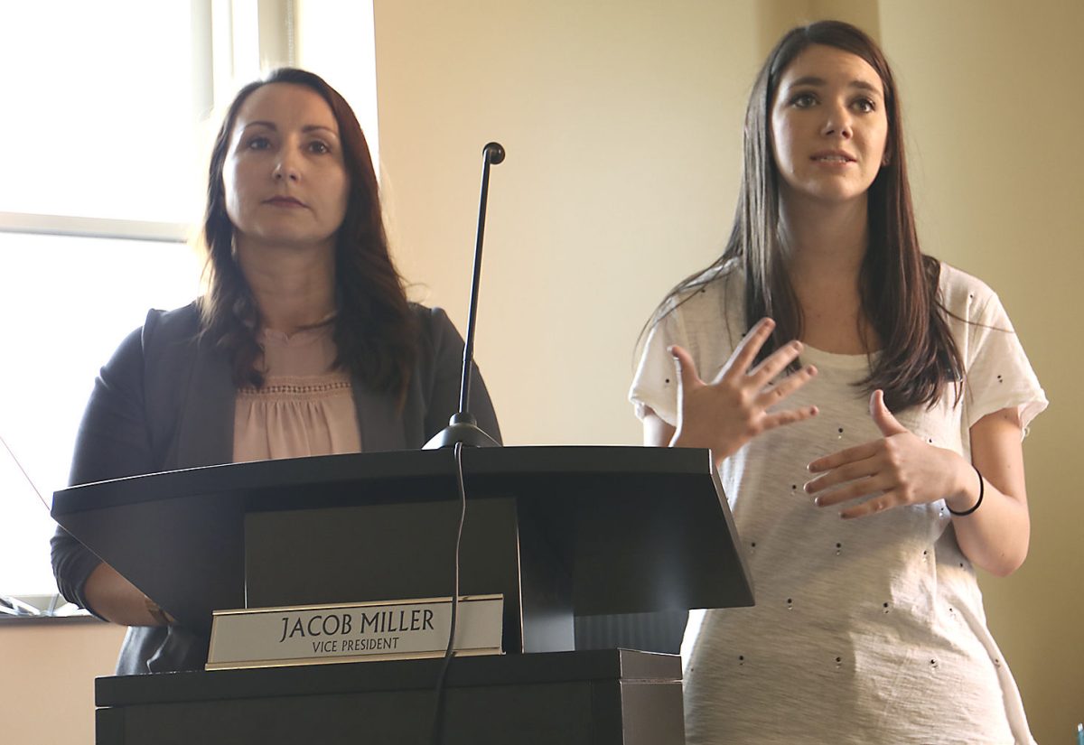 Members of the Tobacco-Free Task Force Brooke Bailey, senior plotical science and communication major, and Daphne Mertens, academic advisor at HPER, speak at the ASG meeting last Thursday. The proposition of no smoking in and around campus was recognized with a vote of 19-0-3 last Thursday in Senate Chamber.