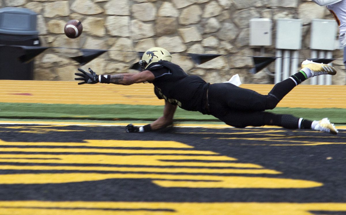 Justin Brown, junior wide receiver, reaches for a pass in the home end zone last Saturday on Jones Field. The game had to be postponed to the next day due to lightning during the game. The Hornets lost 10-27.