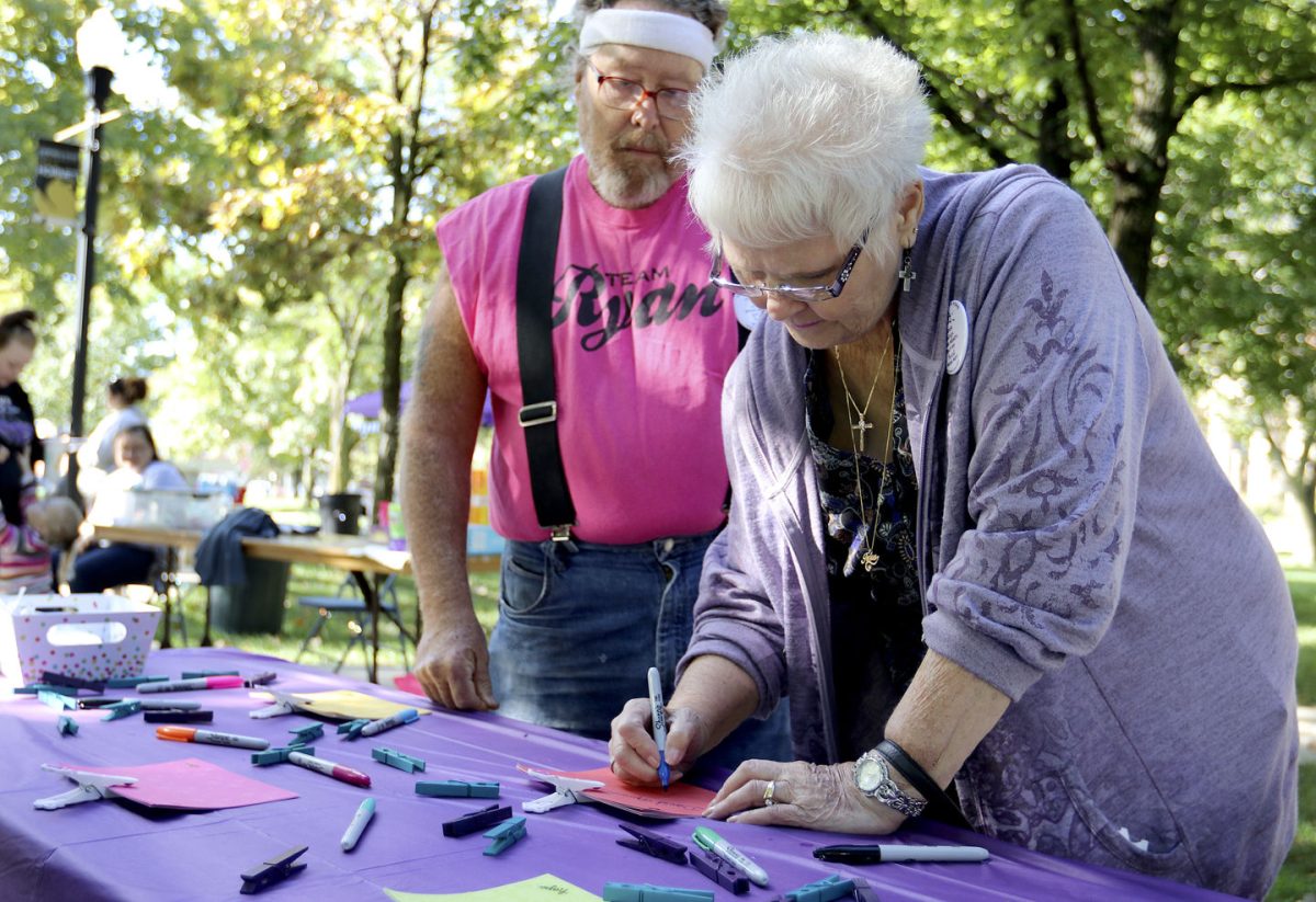 Shannon Spradlin, community member, wrote a letter last Saturday at Kellogg Circle to her son who committed suicide to contribute to the memory wall. Along with the memory wall, on which people hung pictures and notes to remember people whose lives have been lost, there was a raffle, bake sale and other events as a part of the suicide walk hosted by Beacon for Hope.