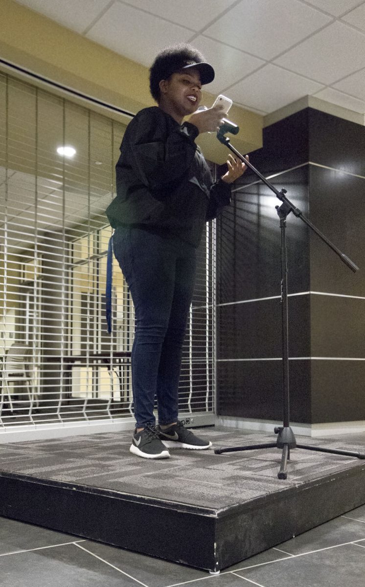 Kayla Gilmore, president of the black student union and junior political science major, performs original poems yesterday in the Memorial Union about being non-binary and pansexual and other poems relating to the Sextober theme and in honor of National Coming Out Day. URGE and Black Student Union worked together to hold their first poetry slam as one of the sex-positive events happening this month.
