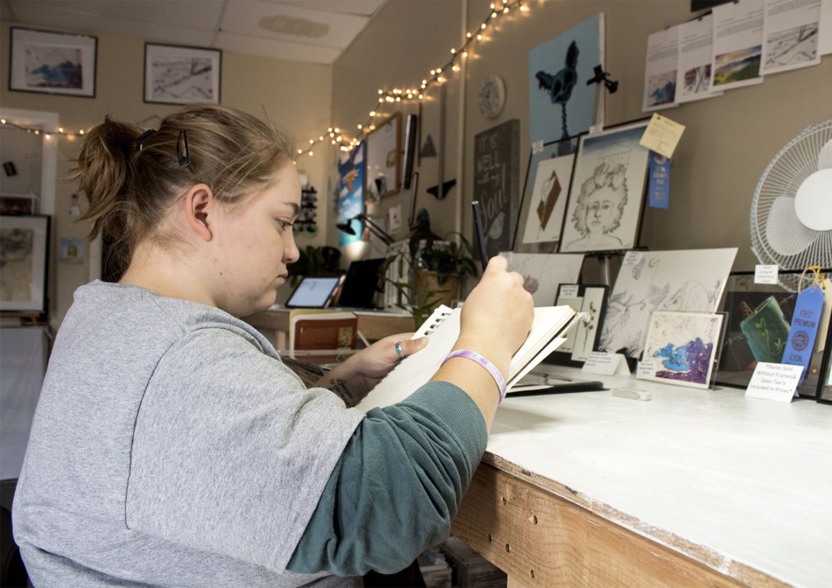 Artist Beth Wright, freshman art education and art therapy major, sketches out the beginnings of a new art piece in her studio on Tuesday. Wright has been renting Duckwalker Studios, 1107A Commercial St., since her senior year of high school.