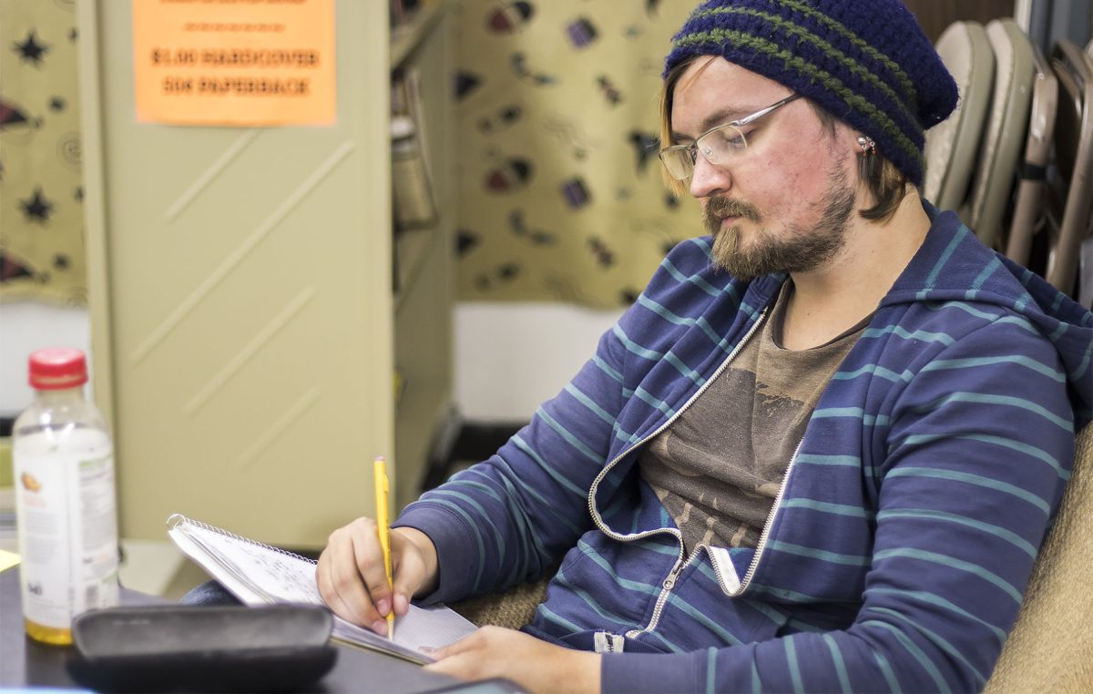 Zachary Palmer, junior interdisciplinary studies major and president of Quivira, works on a psychological horror about the dark side of human psyche, titled &#8220;Abandoned: The Path Marked with a Gravestone&#8221; last Friday in Ellen Plumb&#8217;s City Bookstore. This is the first time he has attempted NaNoWriMo, and by last Friday, he had written about 7500 words.