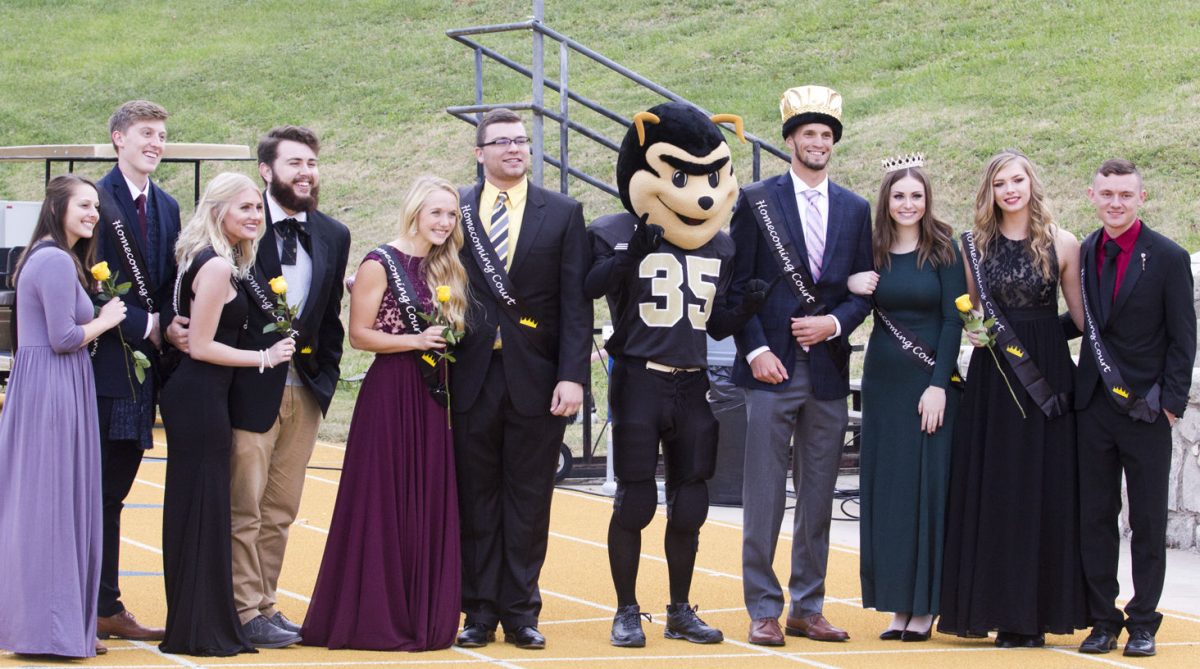 All of the homecoming court candidates pose with Corky after the king and queen were announced during halftime of the football game Saturday at Welch Stadium