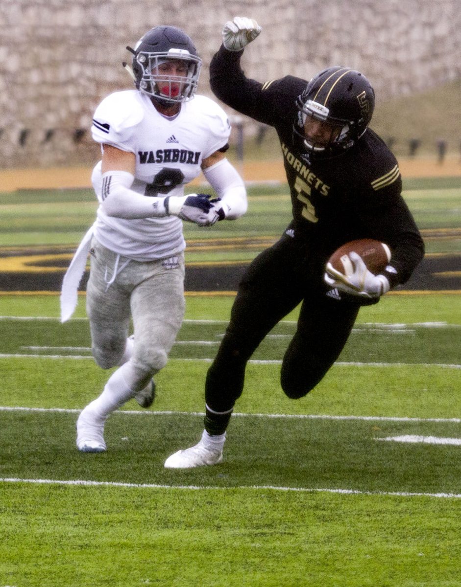 Justin Brown, junior wide receiver, escapes a block from a Washburn Ichabod last Saturday at Welch Stadium. Emporia State Football won 26-20 over Washburn.