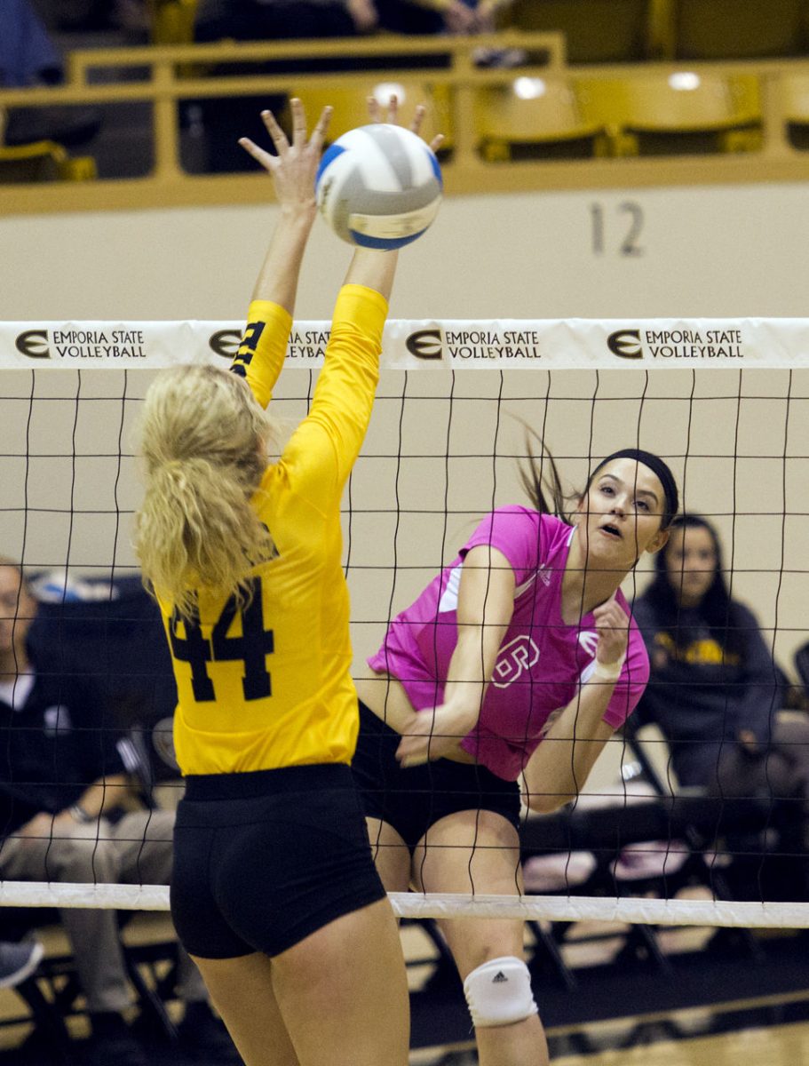 Valerie Golder, freshman middle hitter, spikes the ball Sunday in the William Allen White Auditorium. Emporia State volleyball won in straight sets over Fort Hays State Sunday.