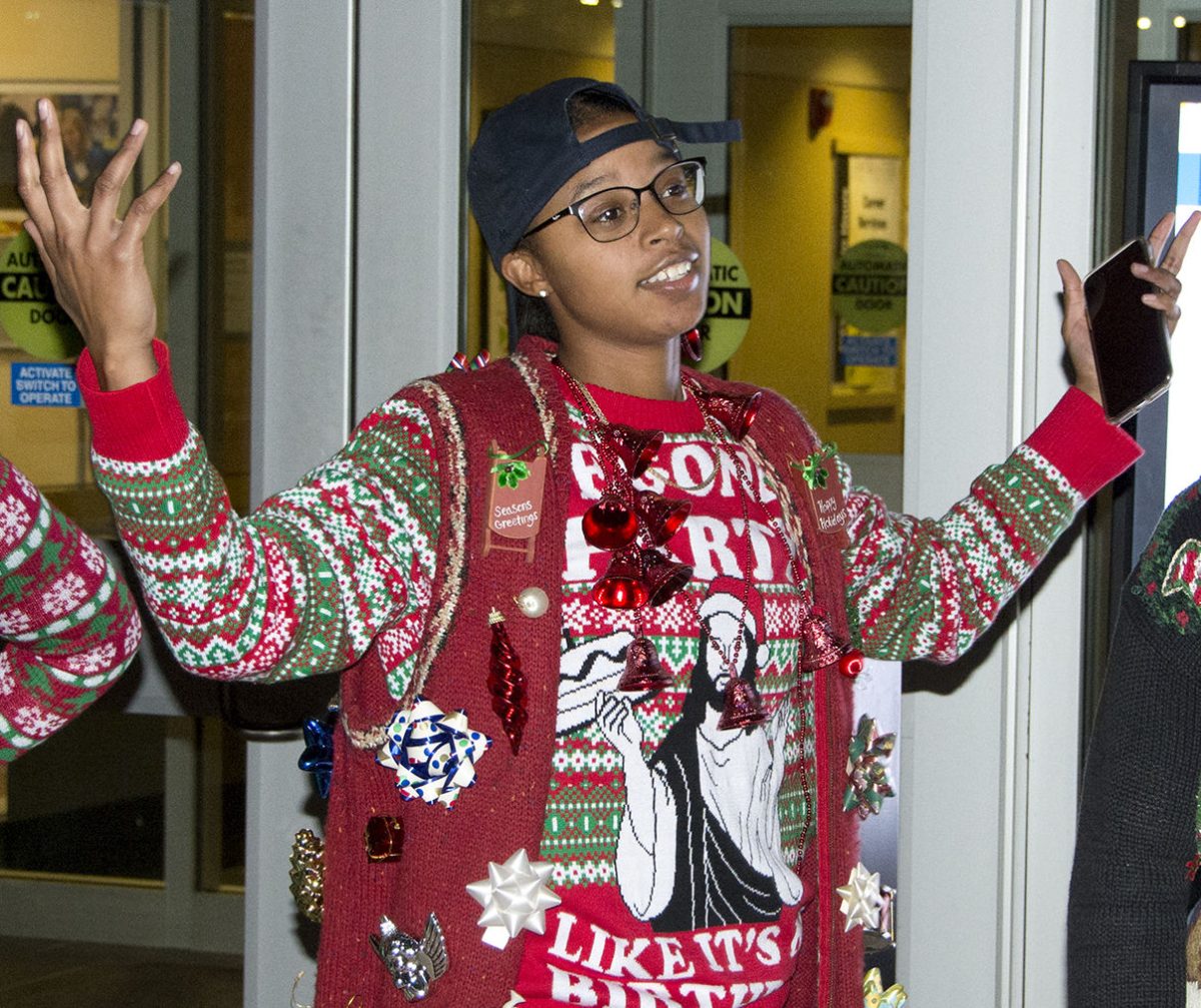 Lati Yeargin Crime , senior delinquency studies, won first prize in the ugly sweater contest Monday during the Mingle and Jingle event on the Wooster Lake patio. Crime received a $100 gift card to the Memorial Union Bookstore.