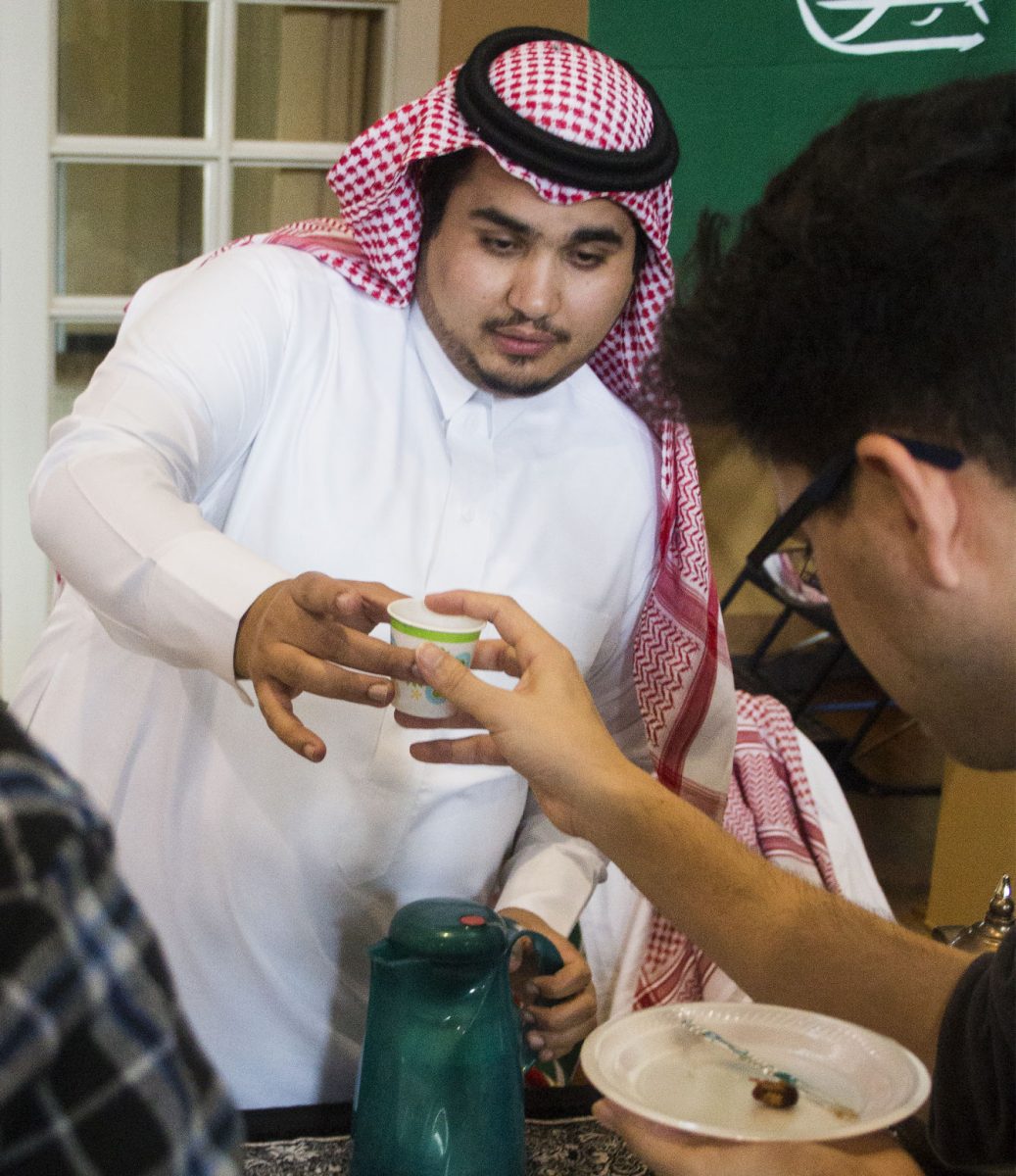 Ali Rudayni, junior communication major, serves tea to Dan Watanabe, program assistant at IDT, on Nov. 17 in the Ballroom. Teas from different cultures in Saudi Arabia, China and Colombia were served at the international tea party.