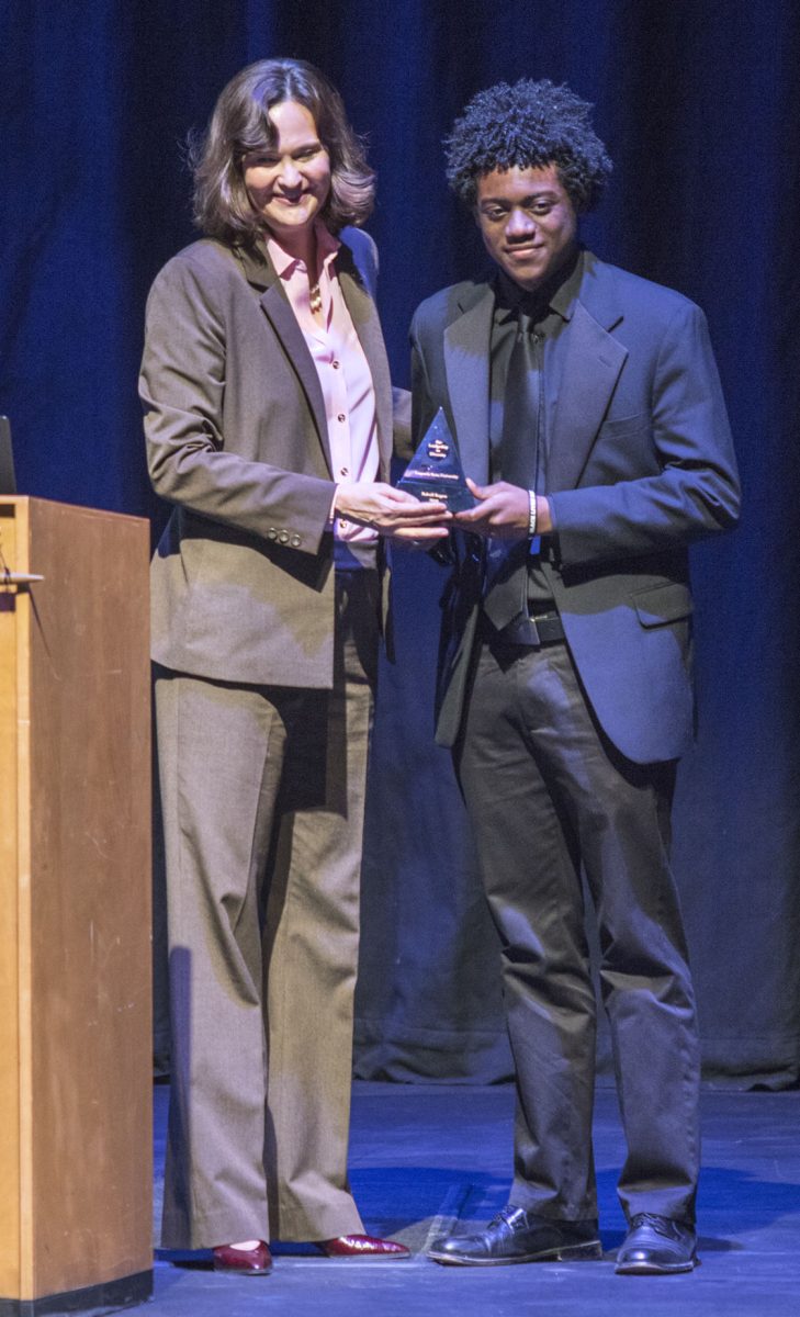 Ralvell Rogers II, senior English major, receives the Presidential Award for Distinguished Service to Diversity from President Allison Garret last Thursday before the Post Traumatic Slave Syndrome lecture by Joy DeGruy in Albert Taylor Hall. Rogers founded the Black Artist&#8217;s Club on campus.