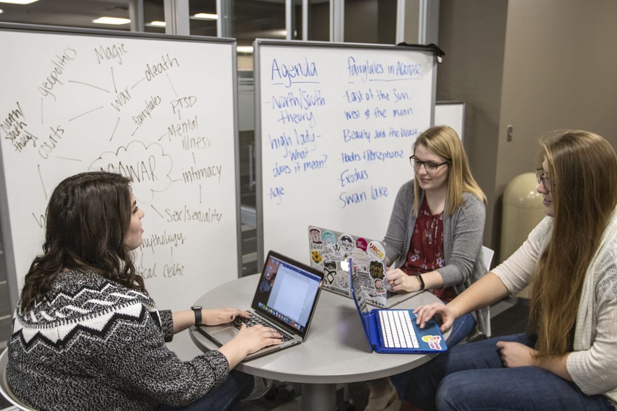 Camille Abdel-Jawad, senior English major, Caylie Ratzlaff, junior secondary education in English and social sciences major, and Katie Dold, senior English major, share their information and ideas about &#8220;A Court of Thorns and Roses&#8221; Tuesday morning in William Allen White Library. They worked with the Honors College and the department of English to create the two credit hour course for themselves.&#160;