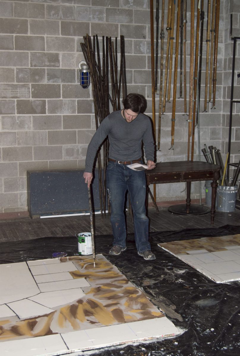 Christopher Evan Granth, junior theater major, paints set pieces in Bruder Theatre last Friday. Bruder Theatre will be remodeled during this summer to update the rigging system, estimated to cost $80,000.