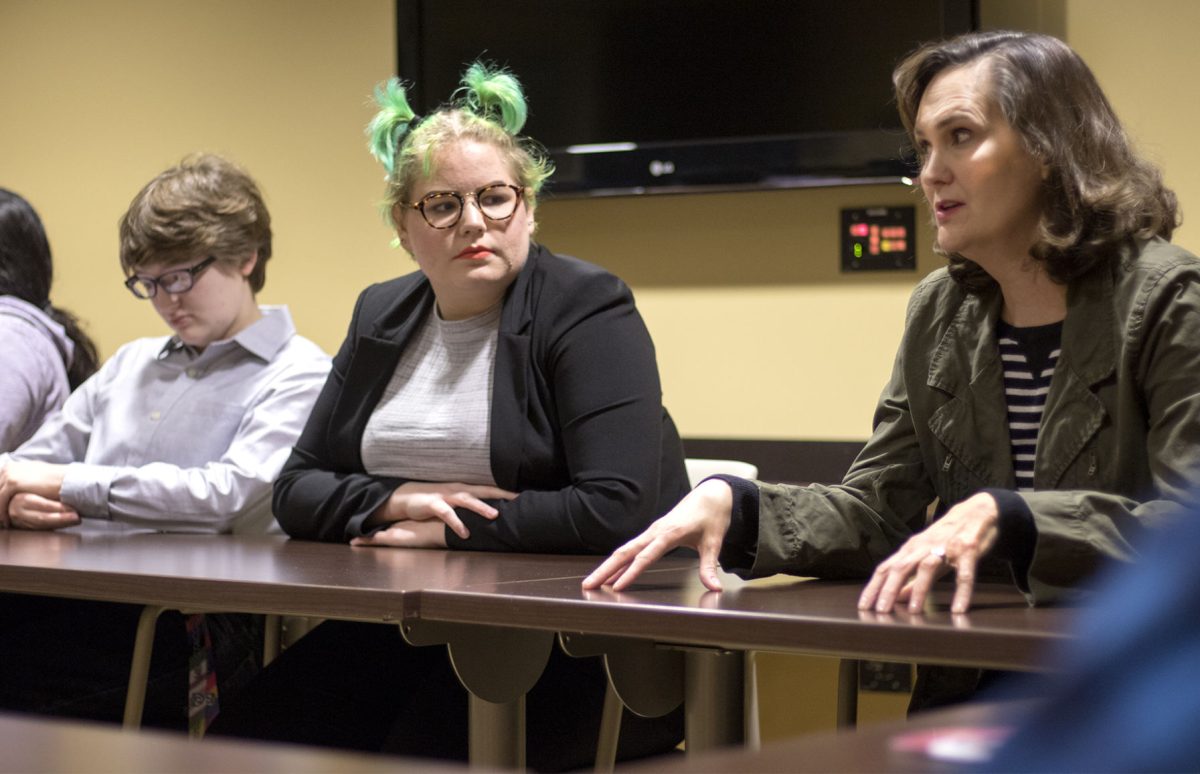 Miranda Boyer, junior history major, Mesa Weidembach, secretary of PRIDE and freshman political science major, as well as other PRIDE members listen to President Allison Garrett yesterday in Miller Room of the Memorial Union speak about the lack of gender neutral bathrooms on the first floor of the union. Garrett made an appearance to the meeting to listen to the concerns of LGBTQ members had about the name for the new campus dorms which are named after Kay Schallenkamp, who removed a clause from ESU&#8217;s Equal Opportunity Statement protecting LGBTQ students from discrimination.