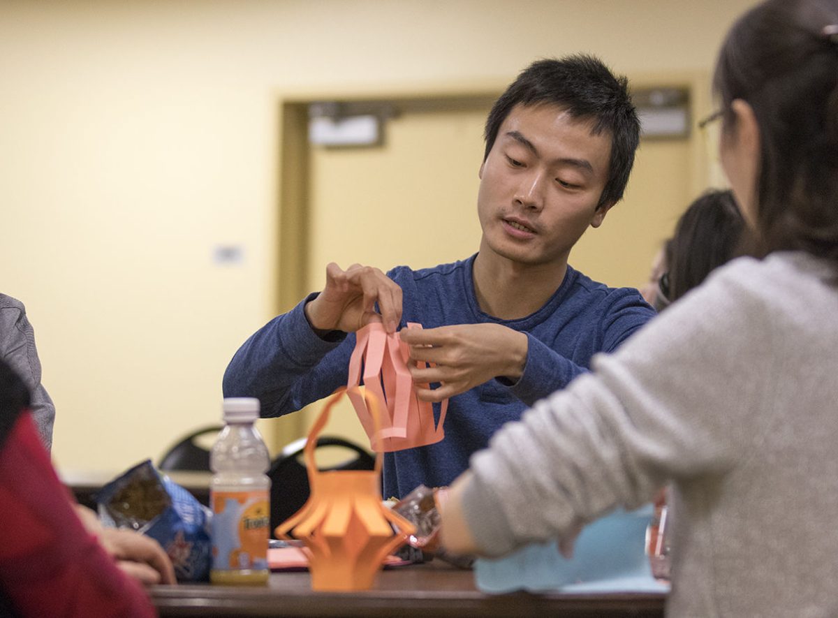 Qiyang Zhang, Chinese Students and Scholars Association adviser and professor of physical sciences, demonstrates how to make a paper lantern on Sunday in Preston Family Room. The Lantern Festival is a Chinese traditional festival to celebrate family reunion.