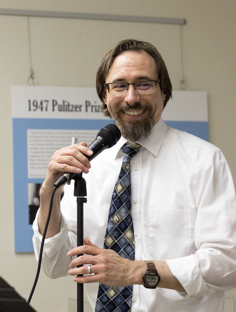 Kevin Rabas, 2018 Roe R. Cross Distinguished professor and chair of the English, modern languages and journalism department, speaks at an open mic event on Friday in William Allen White Library. &#8220;I see the impact that he&#8217;s having on students&#8230; and I just knew he was a great candidate,&#8221; said Amy Sage Webb, professor of English and one of the professors to nominate Rabas.