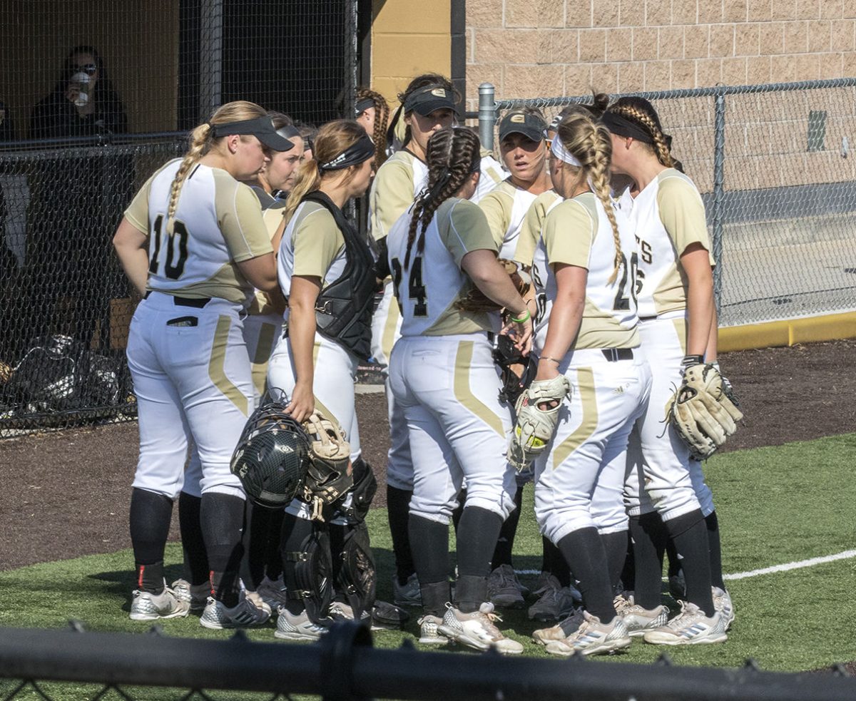 The softball team huddles together during a game against Washburn Friday at the Trusler Sports Complex. The Hornets lost both games against the Ichabods and will have another home game Tuesday, April 10 against Newman University.