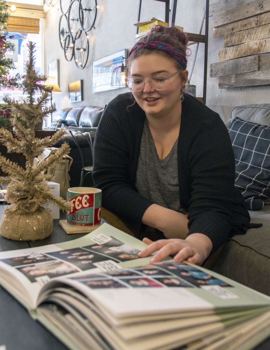 Chloe Soetaert flips through a copy of the yearbook at Gravel City Roasters, 608 Commercial St. and talks about her time at &#8220;The Sunflower&#8221; yearbook.&#160;