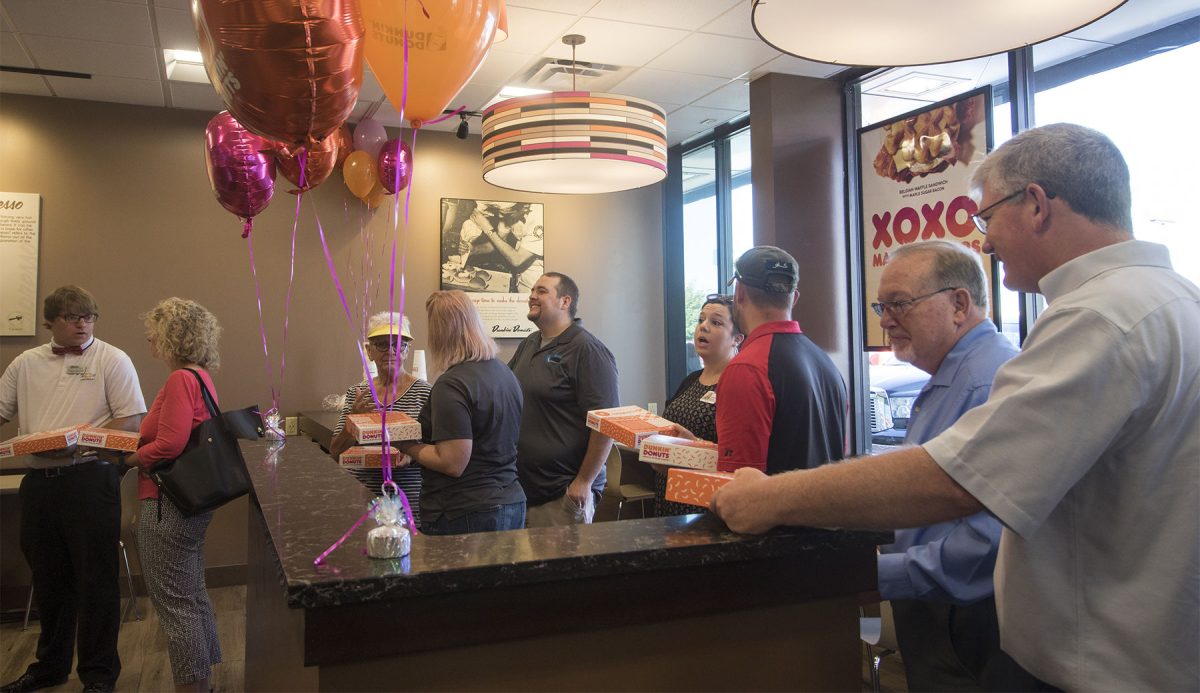 Attendees of Dunkin' Donuts' grand opening wait in line for complementary donuts on Friday in the Dunkin' Donuts store, 2000 Industrial Rd. Dunkin' Donuts officially opened last Wednesday.