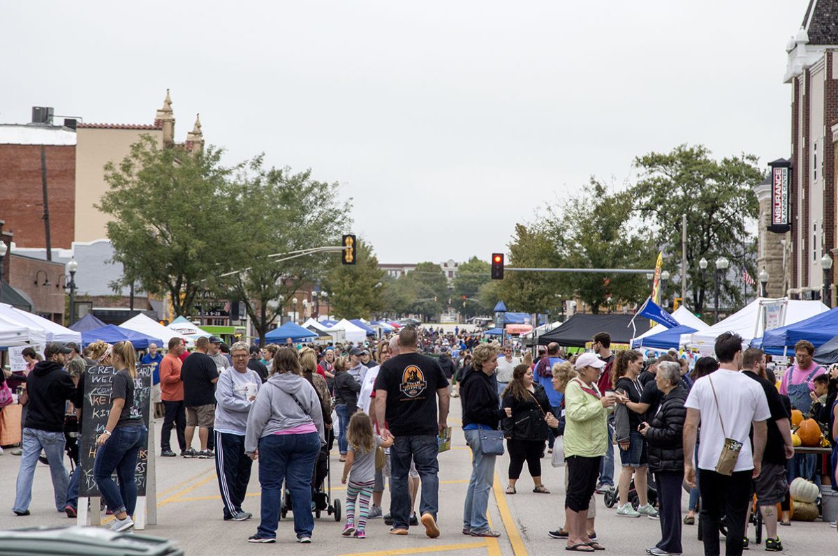 Community members walk down Commercial street last Saturday during the Great American Market. The market was filled with local sellers of handmade crafts and other items.&#160;