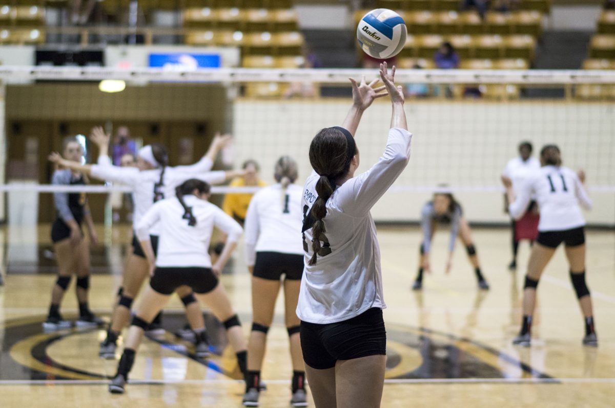 Tatum Graves, senior middle hitter, serves the ball during a game against Fort Hayes State on Saturday at White Auditorium. Tatum had 13 kills, 1 ace, and 5 blocks, according to esuhornets.com