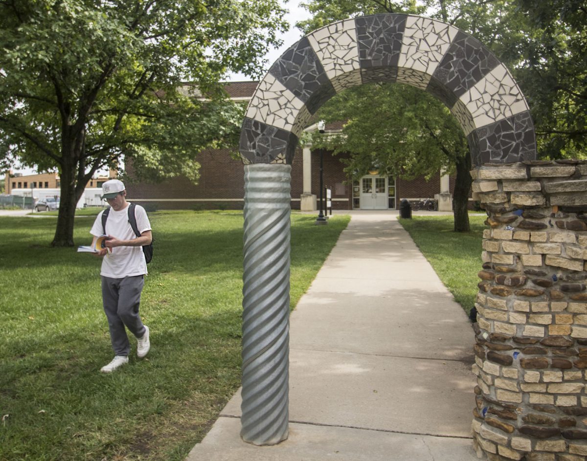 Steven McDermott, senior music education major, walks around the arch yesterday between Beach Hall and King Hall. There is a tradition on campus for students to avoid walking under the arch or else they will not graduate on time.
&#160;