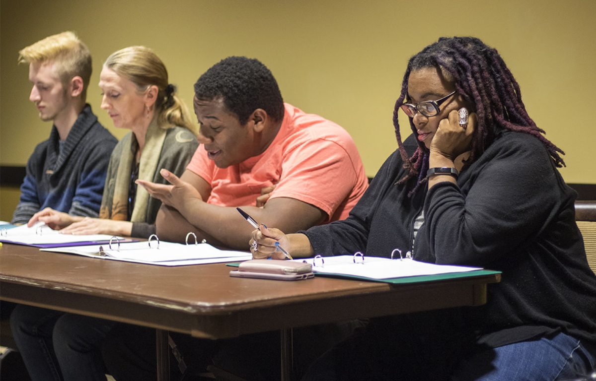 Michelle Tyrene Johnson (far right), playwright and author, reads a character from a new play &#8220;Buried Roots&#8221; with Hewleek McKoy (right), senior theater major, Amy Sage Webb (left), professor of English, modern languages and journalism, and Alec Walberg (far left), junior communication major last Thursday in the Kanza Room. Johnson made a promise to students to finish the play by Dec. 5.&#160;