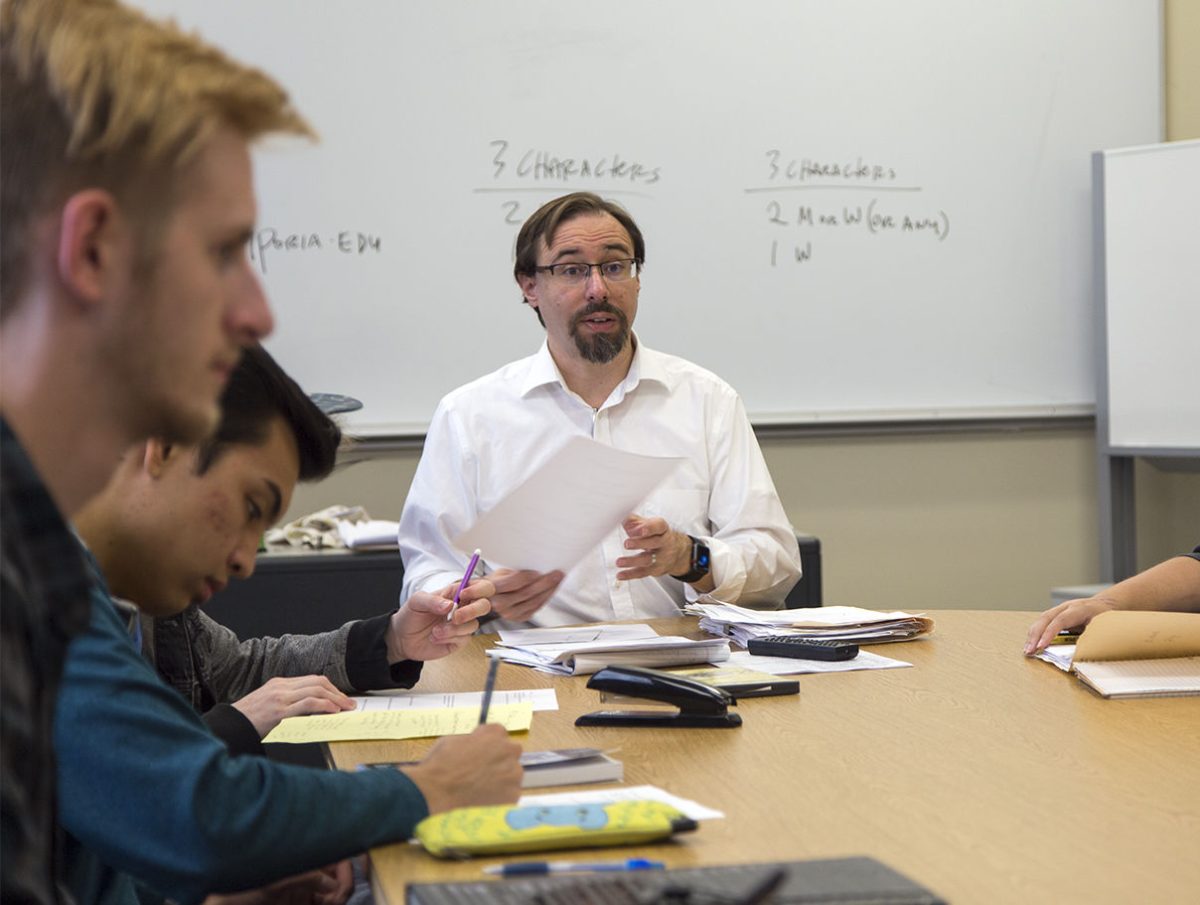 Kevin Rabas, chair of English, modern languages and journalism, helps students with their original playwrights during one of his classes in Plum Hall. The students will preform their pieces at the Short Play Festival on Saturday in Fredrickson Theater.&#160;&#160;