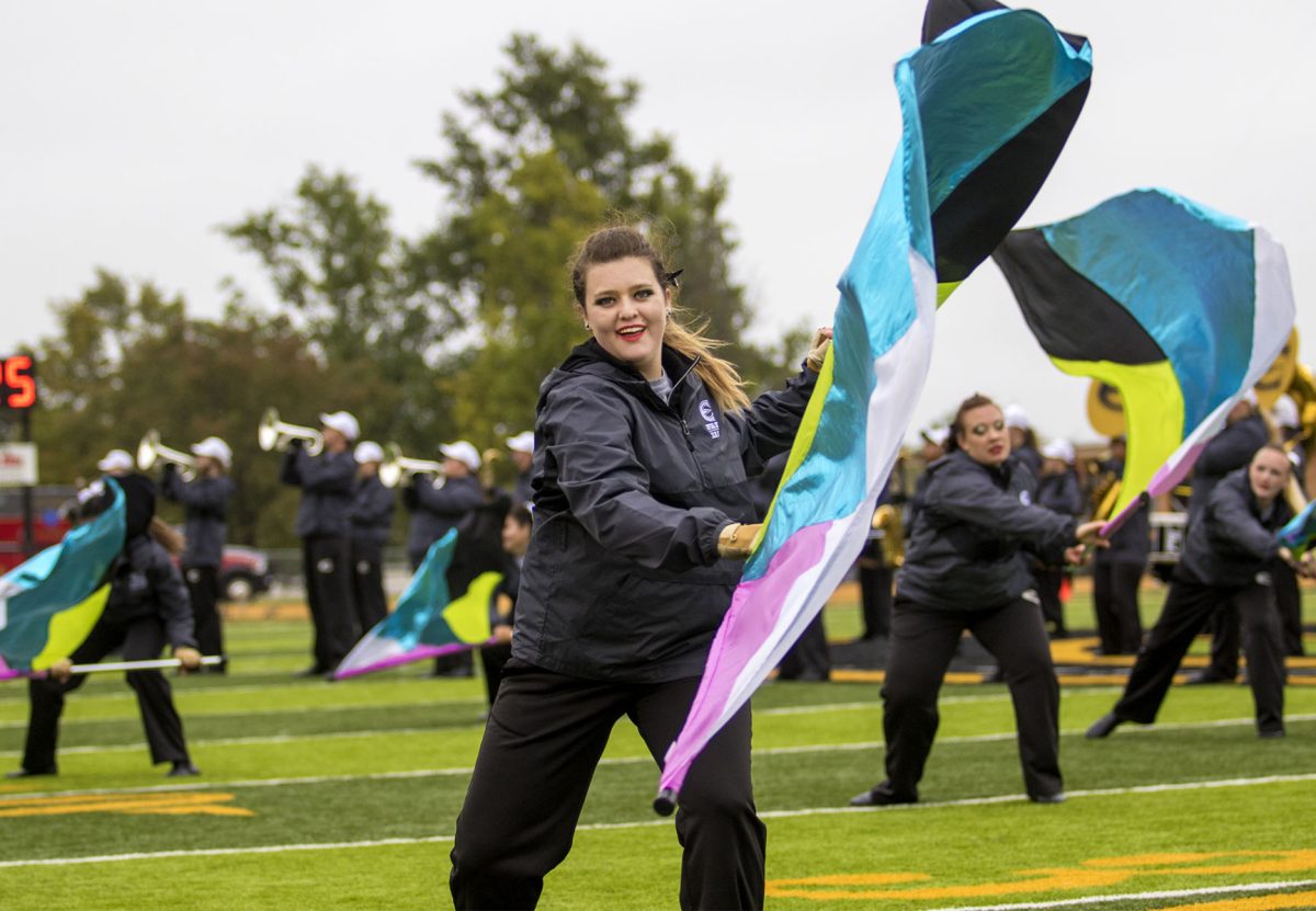 Katherine Beckley, sophomore math education major, performs in the Marching Hornets color guard during the half time performance Oct. 6 at Welch Stadium. The color guard has been invited to perform next Wednesday in Andover, Kansas at the Southern Plains Marching Festival.&#160;
