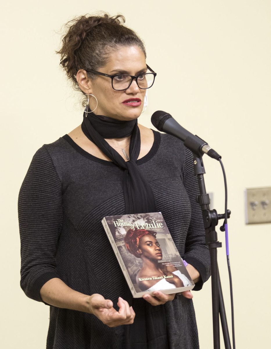 Kristen Imani Kasai, poet, novelist, publisher and magazine editor shows off the cover of her newest book, &#8220;The House of Erzulie.&#8221; The book features cover Kasai&#8217;s daughter.&#160;