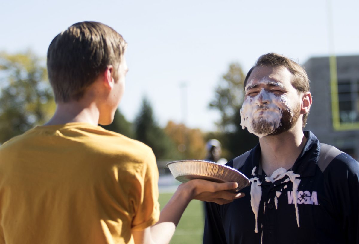 Michael Webb, Associated Student Government president and senior business administration major, pies Zac Surritt, Washburn&#8217;s ASG president after Emporia State was announced as the winners of Can the Bods. ESU collected 50,891 cans while Washburn had 34,214 cans.&#160;