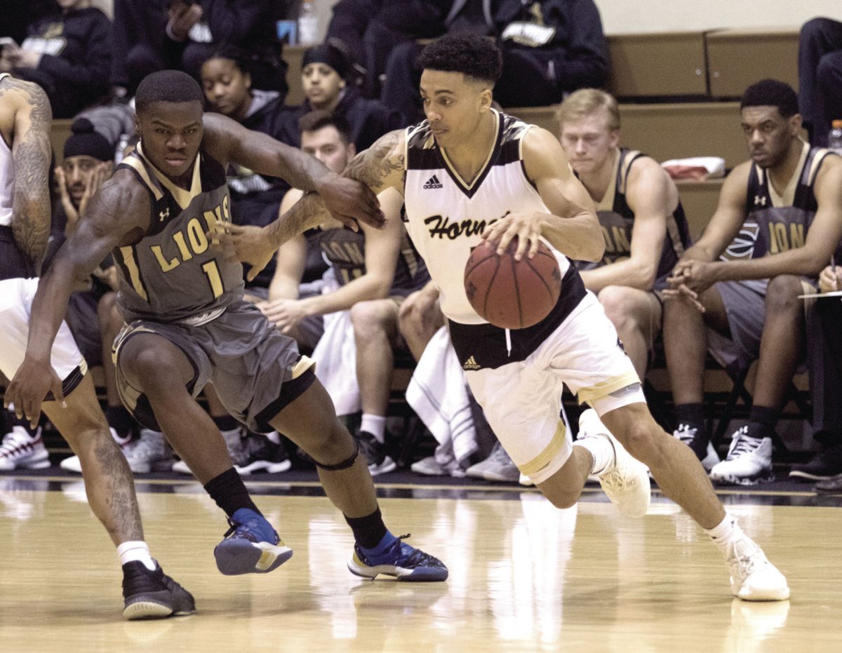 Malik Hluchoweckyj, senior guard, tries to get around a Lion during the game on Thursday against Lindenwood at White Auditorium. The Hornets scored 85-68 after four consecutive losses.