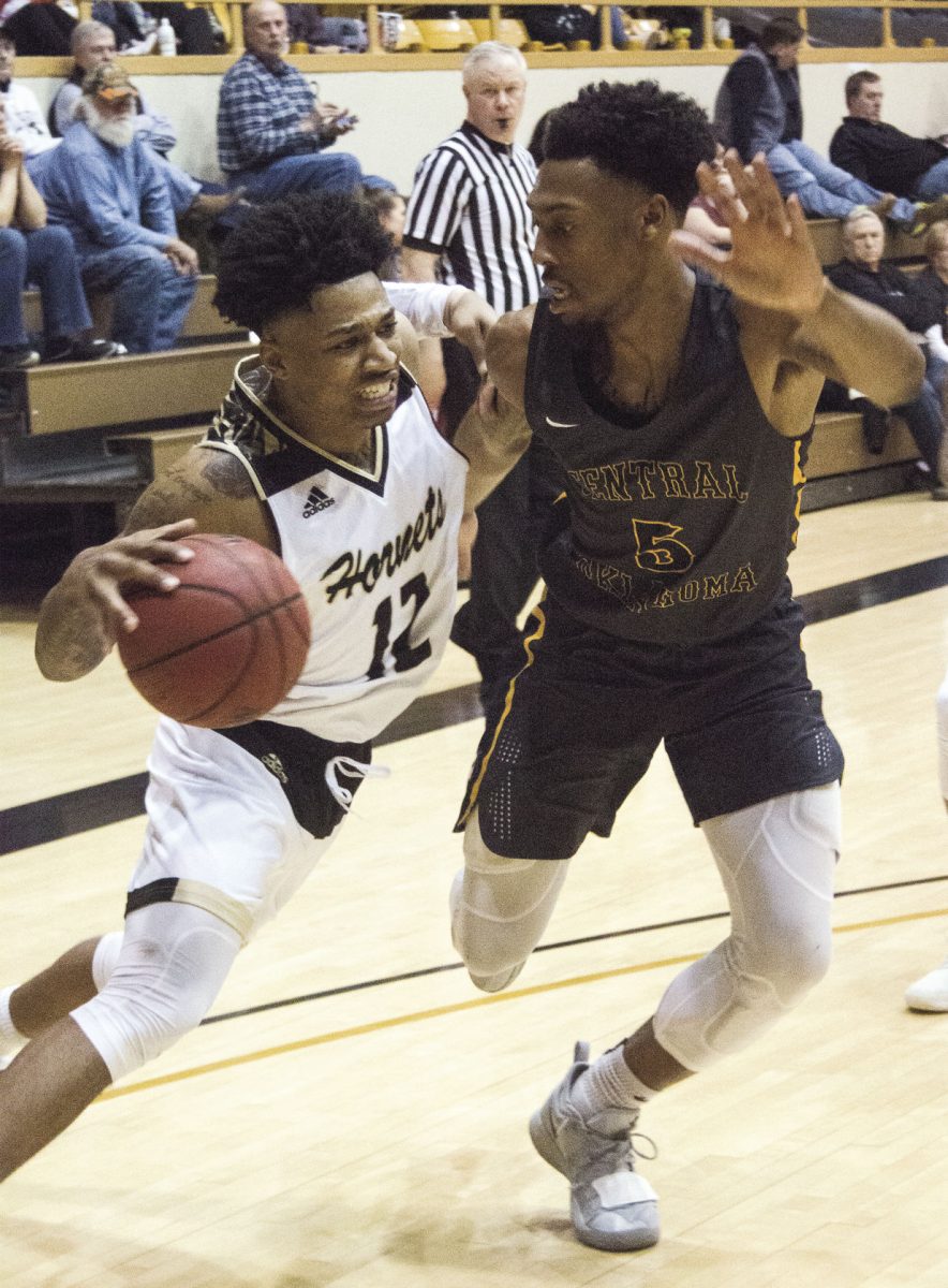 Julius Jackson, senior guard, dribbles around a Bronco last Thursday at White Auditorium. Jackson led with 26 points, helping the Hornets to win 66-63 over Central Oklahoma.&#160;