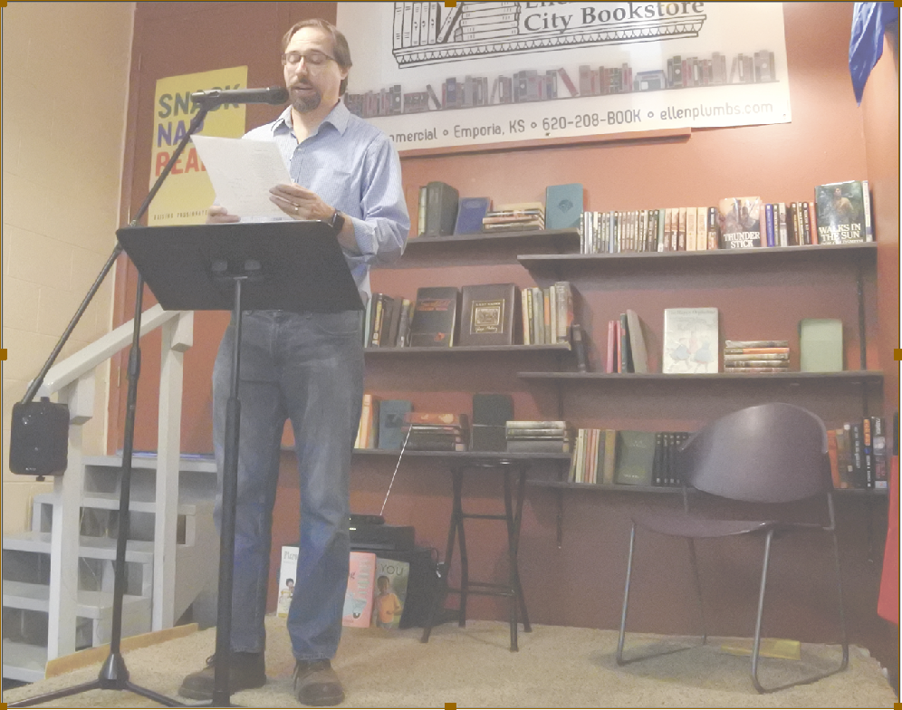 Kevin Rabas, chair of in English, modern languages and journalism, reads his poem &#8220;Kansas, Awakening,&#8221; during the Kansas Author Showcase Saturday in Ellen Plumb City Bookstore. The showcase featured other Kansas authors in honor of Kansas Day.