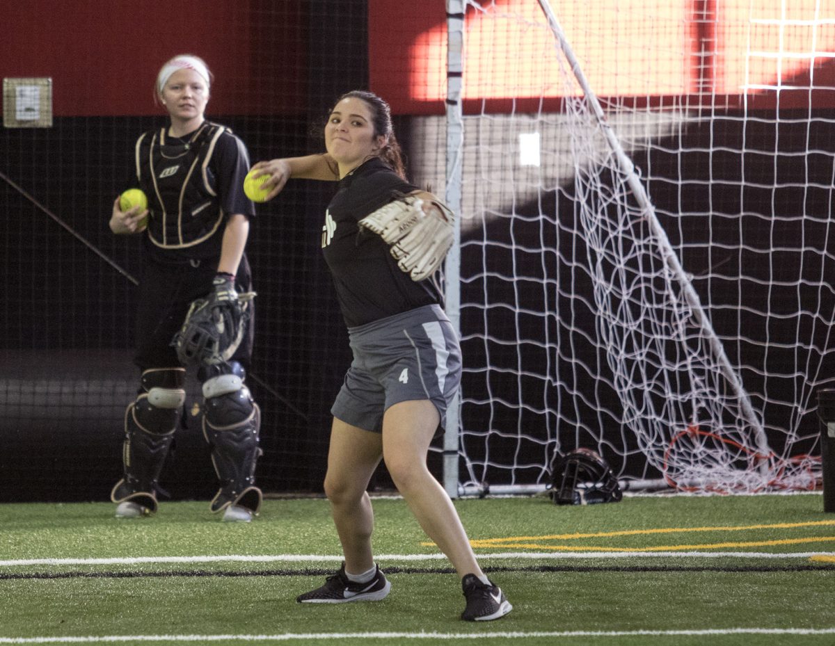 Montana Mesler, sophomore outfielder, practices drills Monday in Jones Activity Complex. The softball team has been forced to practice inside due to the recent cold weather.&#160;
