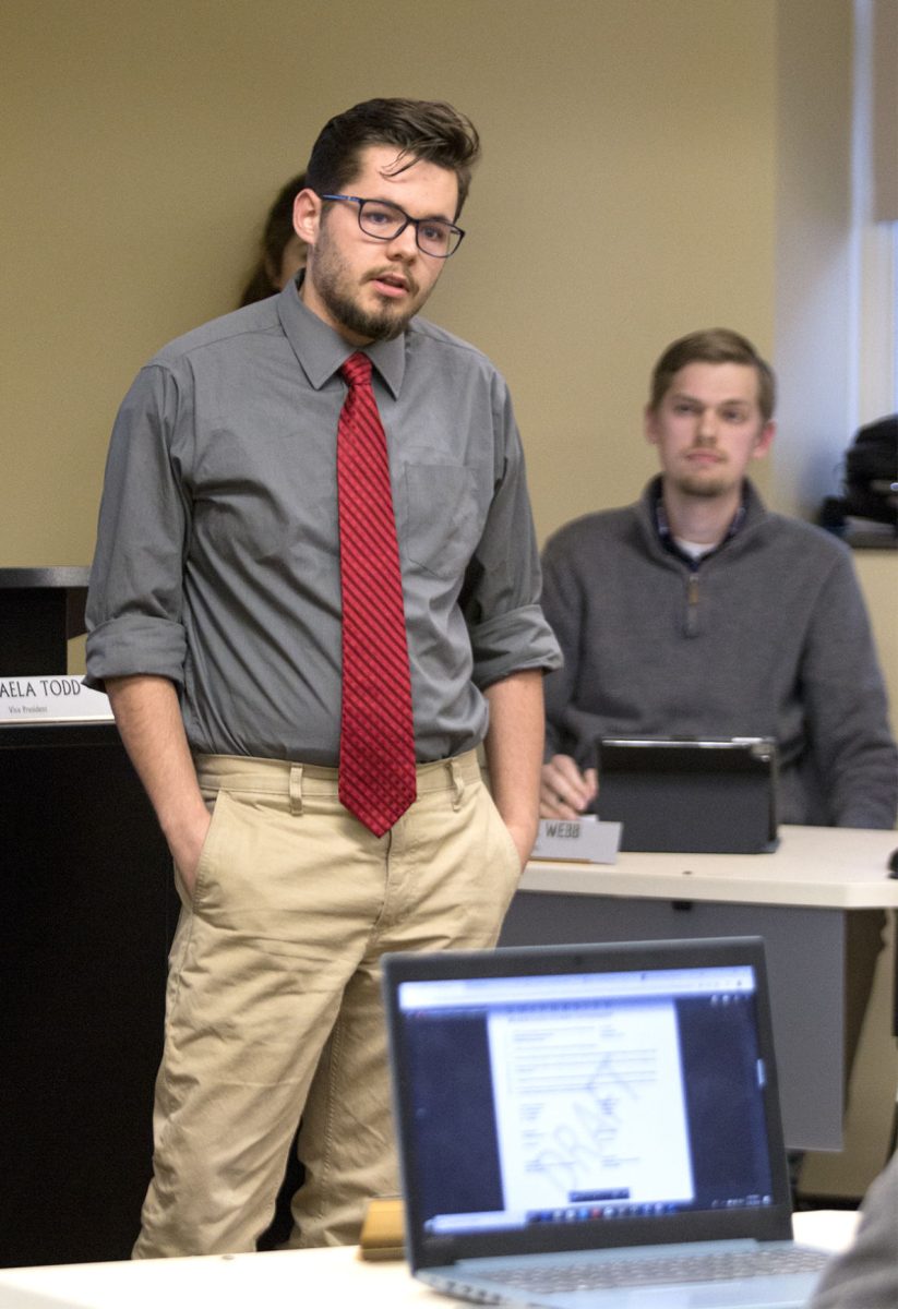 Logan Fisher, Phi Sigma Kappa treasurer and sophomore economics and mathematics major, talks to Associated Student Government about the midwestern conclave at the ASG meeting Feb. 21 in the Senate Chambers. PSK was requesting $1,100 from ASG to help cover travel costs, which was approved.&#160;