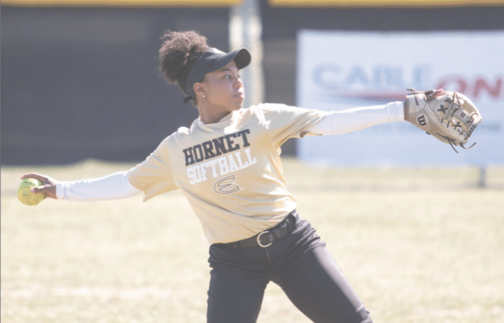 Destiny Ojigoh, sophomore pitcher, throws the softball during practice yesterday at Trusler Sports Complex. Ojigoh, who was born in Canada, recently gained her U.S. citizenship with the help of her teammates who quizzed her on rides to games.