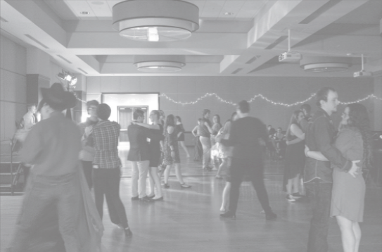 Students dance at the Spring Ball yesterday in the ballroom. About 60 canned food items were raised to donate to Corky&#8217;s Cupboard.