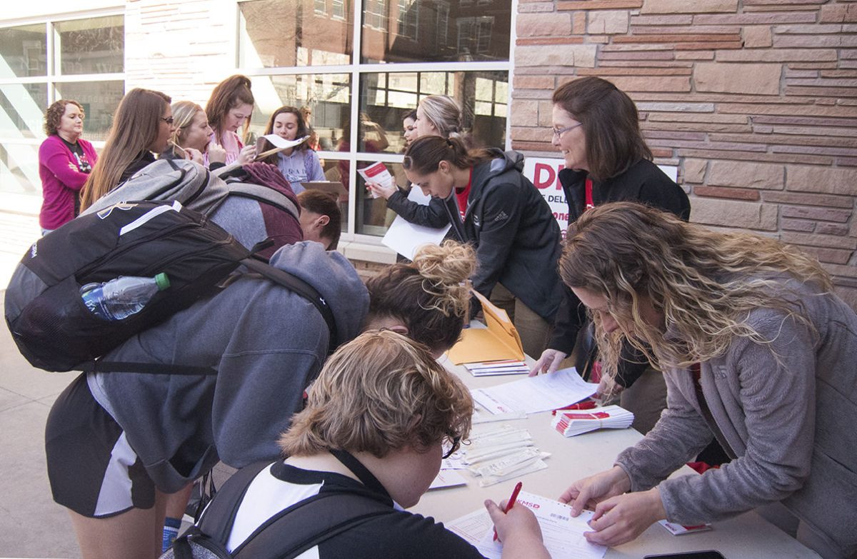 Students register and swab for the DMKS drive on Friday outside the Memorial Union. The drive took added 349 students to the registry in two days.