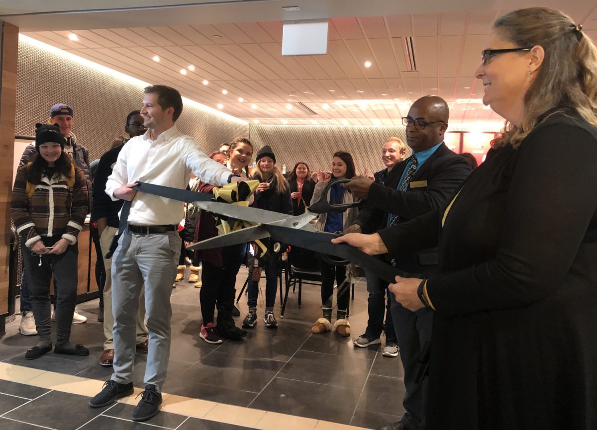 Myron Bridges, general manager of Sodexo cuts the ribbon at the grand opening of the new Starbucks in the Memorial Union on Nov. 12. At this event there were free samples and plenty of Starbucks lovers waiting to place their orders.