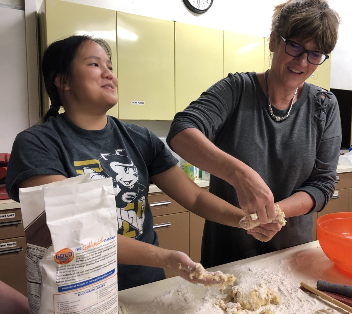 Mary McDaniel Anschutz, director of Health Services, helps Joie Whitney, senior health and human performance major, make homemade noodles at the second C.H.E.W event of the semester on Nov. 7 at the First Christian Church. C.H.E.W is a free event that teaches students how to cook healthy.&#160;