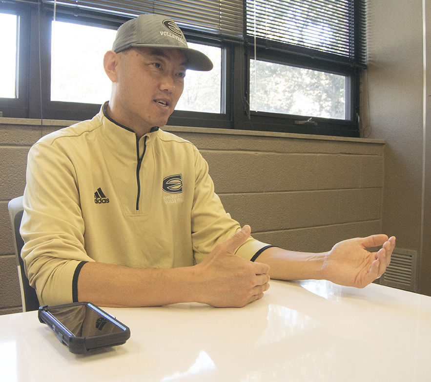 Bing Xu, head volleyball coach, speaks about The Epoch Times and what it means to him on Nov. 3. Xu has been distributing the Chinese language newspaper for three years and currently drops off copies to William Allen White Library.