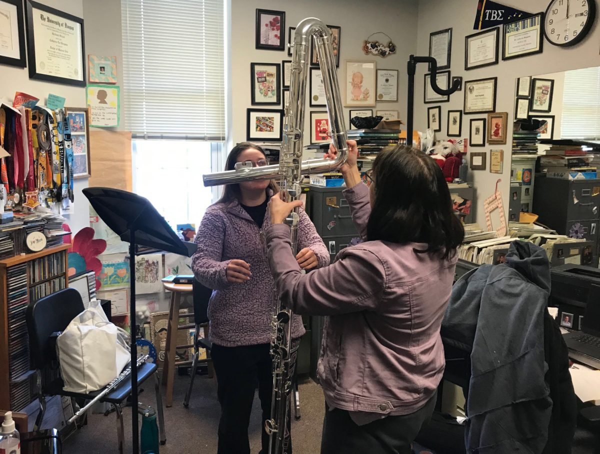 Kayla Leiber, senior flute performance major, puts together the 8-foot-tall Contrabass flute with Catherine Bergham, music professor. The flute is the newest edition to the music program.