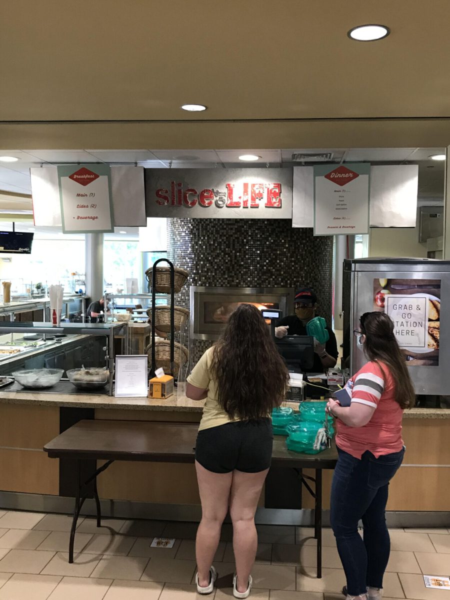 ESU students order Slice of Life outside the Hornets Nest. Dorm residents were given green food bins to eat and transport food with.