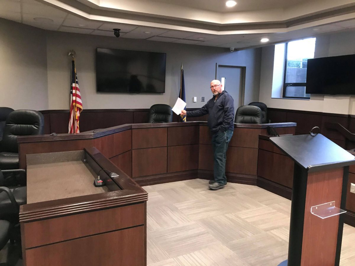 Mike Henderson shows where the presiding judge, Ted Hollembeak, and several other court staff can sit. With seven chairs set up, Henderson stated that the goal is to limit as many people from being in the room together as possible.&#160;
