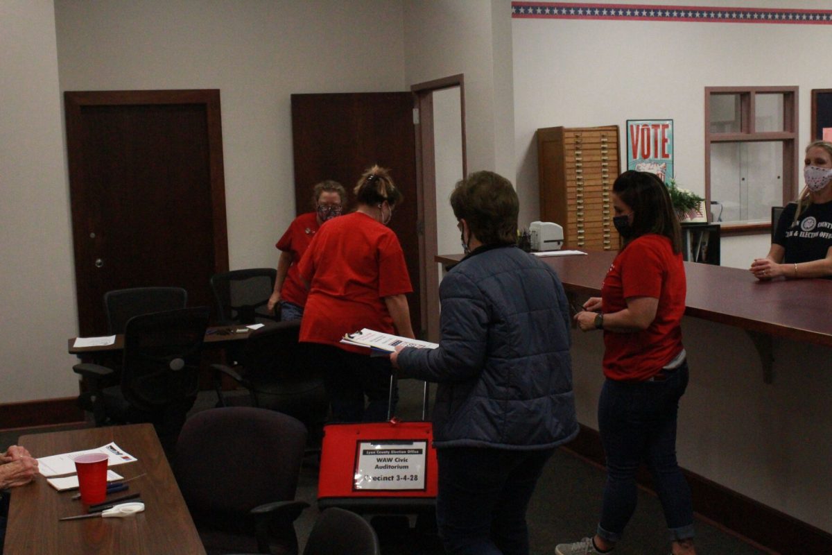 Poll workers from the William Allen White&#160;auditorium arrive with the first results of the night. According to Election Officer Tammy Vopat, workers will be sorting through ballots well into the night as results continue to come in.&#160;