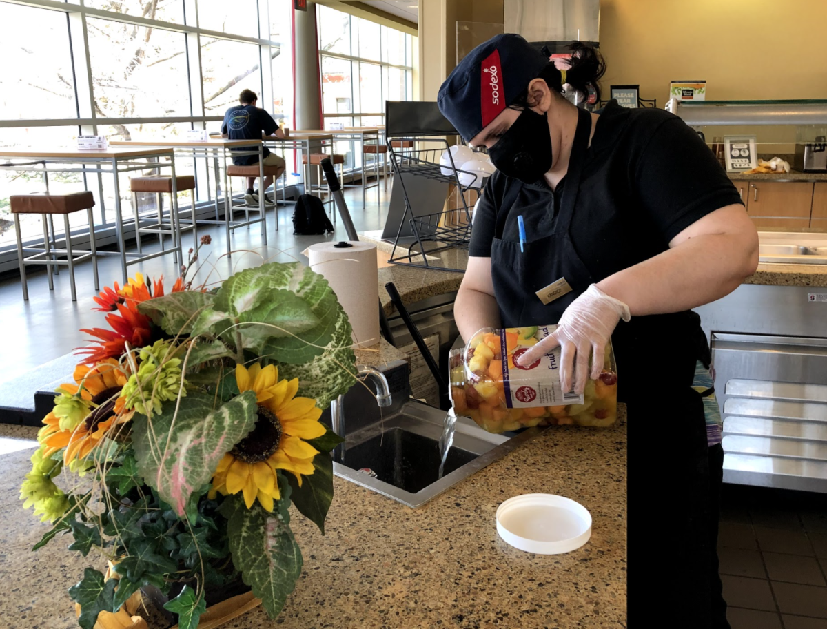 A Sodexo employee prepares for the lunch rush by restocking the fruit and sanitizing equipment on Thursday, March 4. Of the 18 schools interviewed by the group, seven use Sodexo as their food provider including Emporia State.